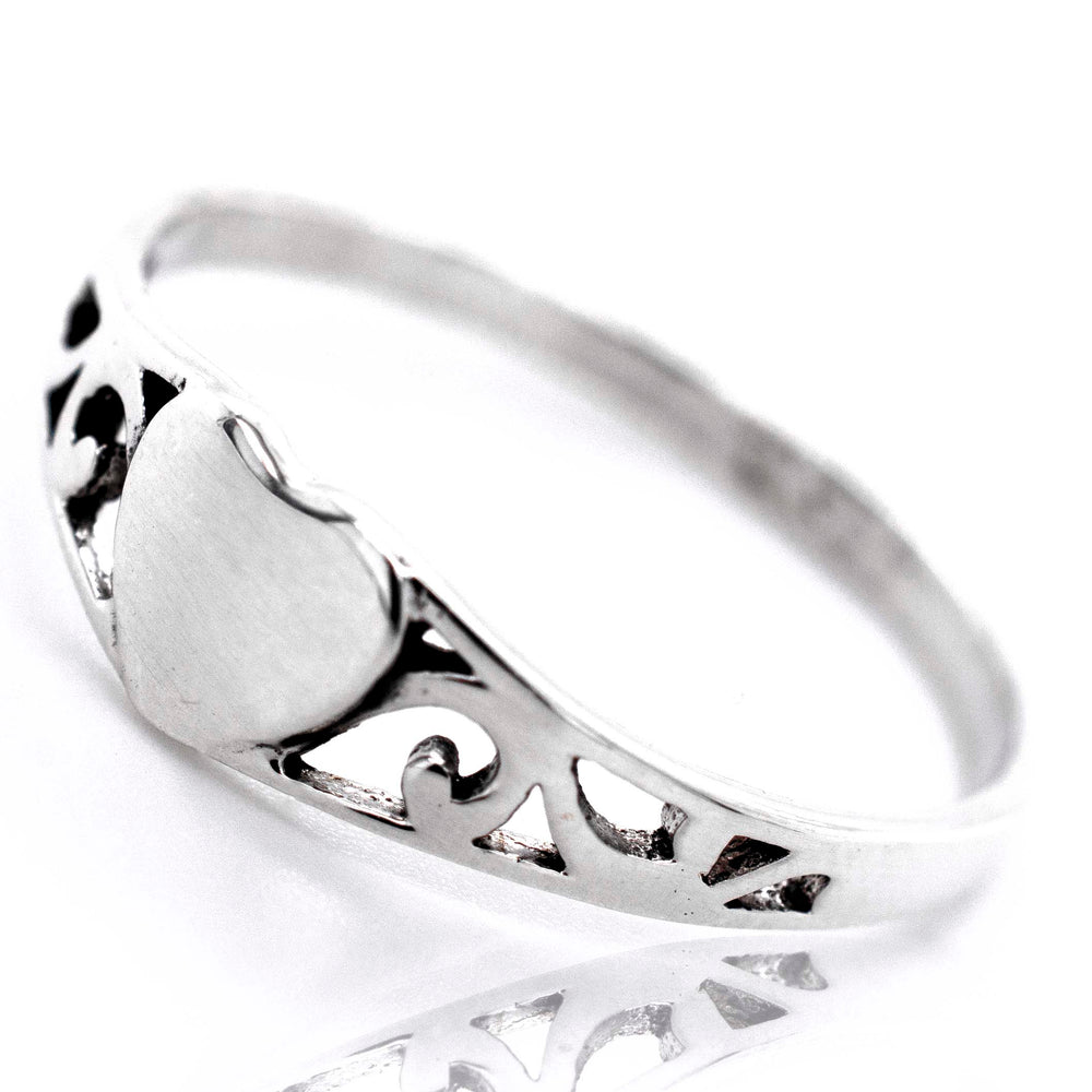 
                  
                    A minimalist sterling silver Heart Ring With Swirl Design.
                  
                