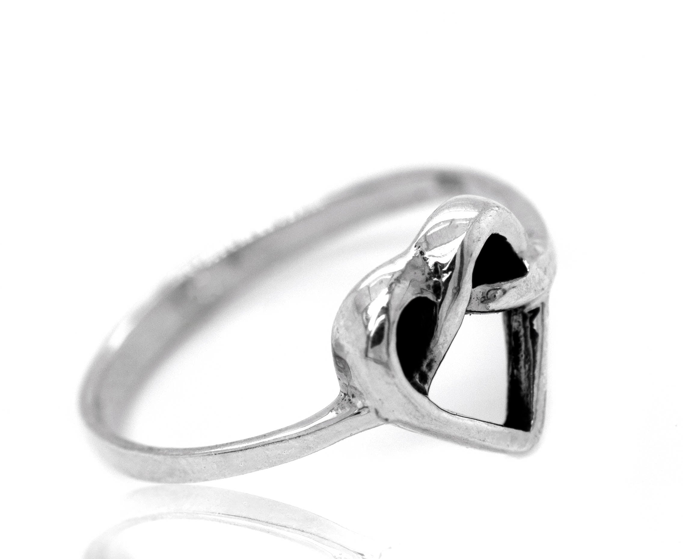 A silver Entwined Heart Knot Ring adorned with black stones, symbolizing love and affection.
