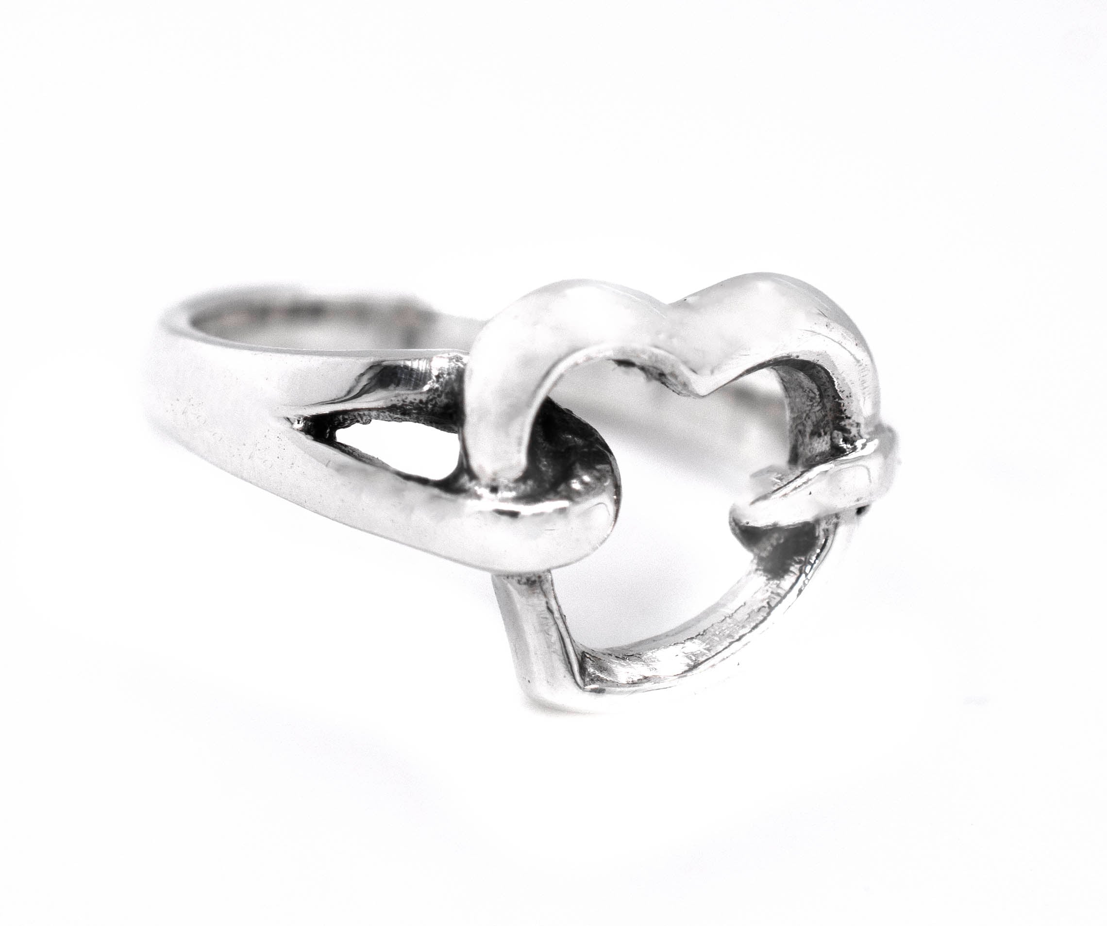 A minimalist Open Heart Double Knot Ring on a white background.
