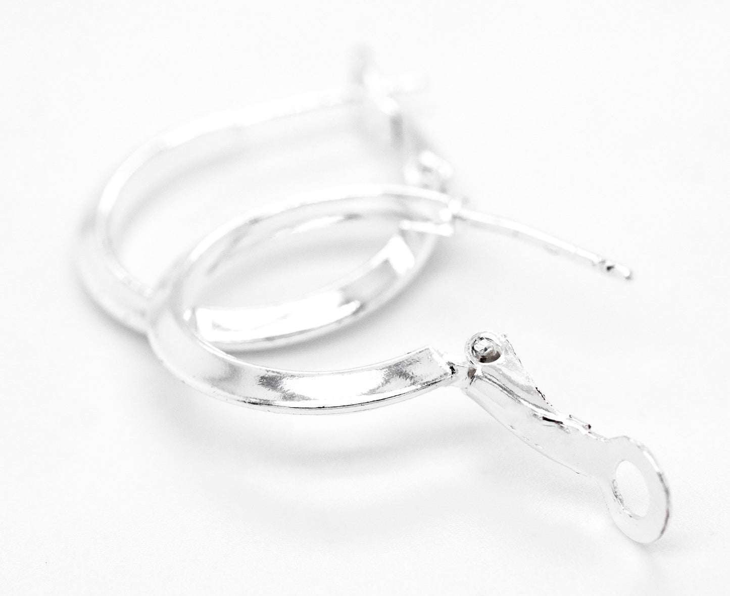 A pair of Easy Latch Hoop Earrings from Super Silver on a white surface.
