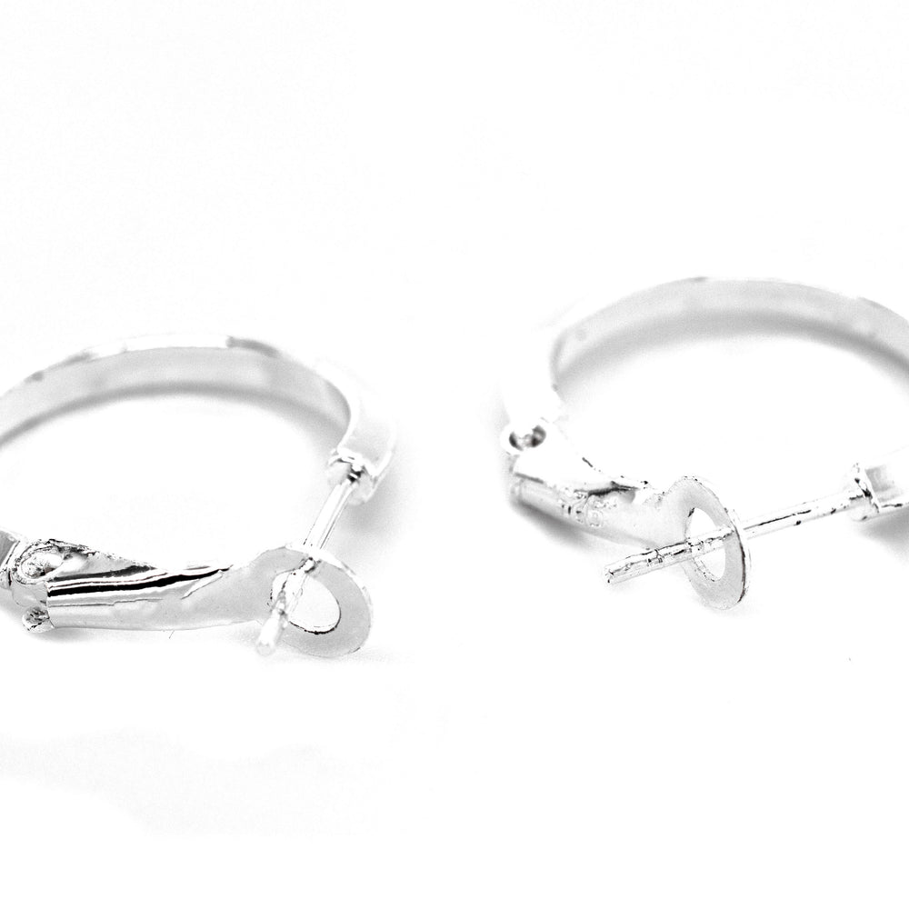 
                  
                    A pair of Easy Latch Hoop Earrings by Super Silver on a white background.
                  
                