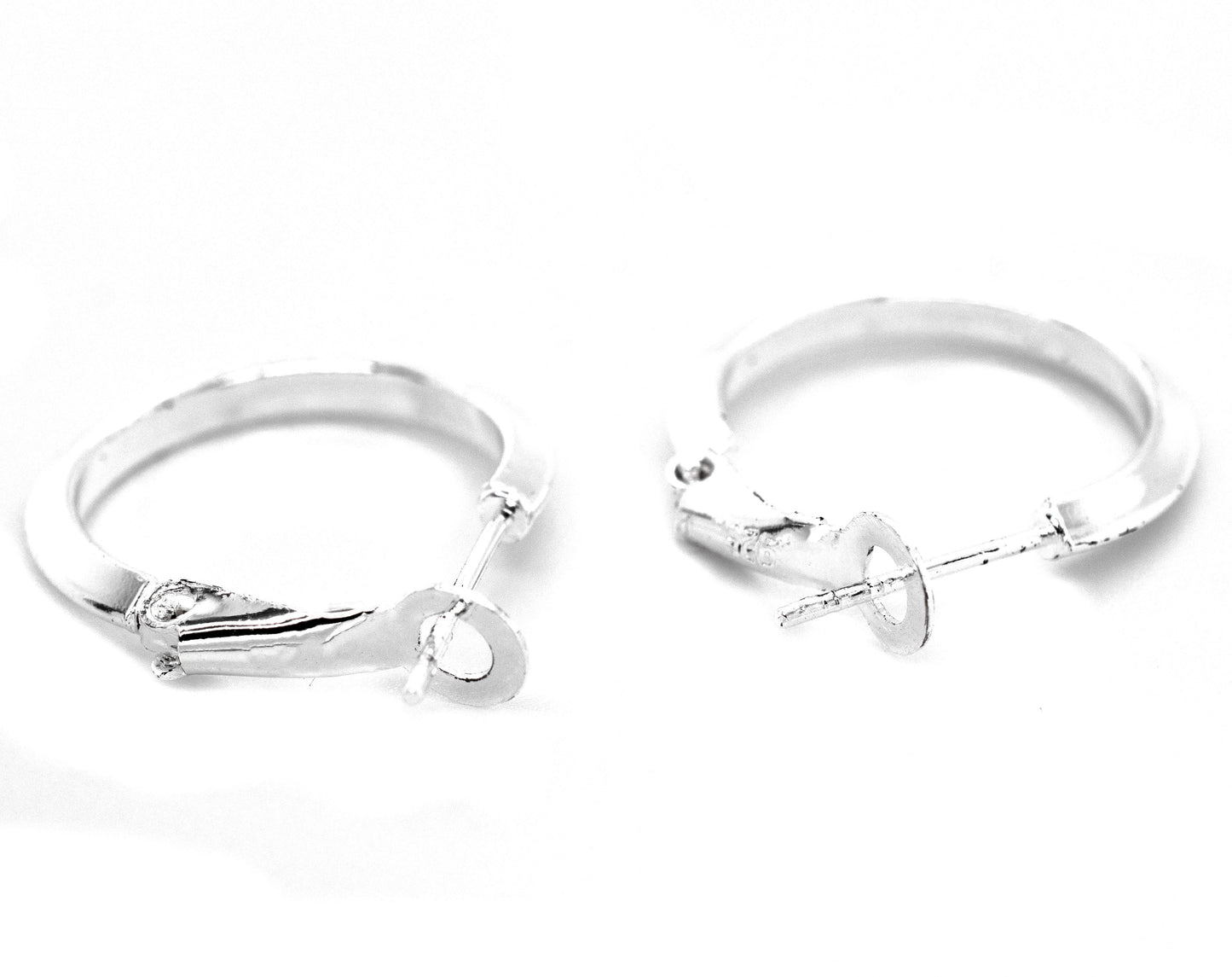 
                  
                    A pair of Easy Latch Hoop Earrings by Super Silver on a white background.
                  
                