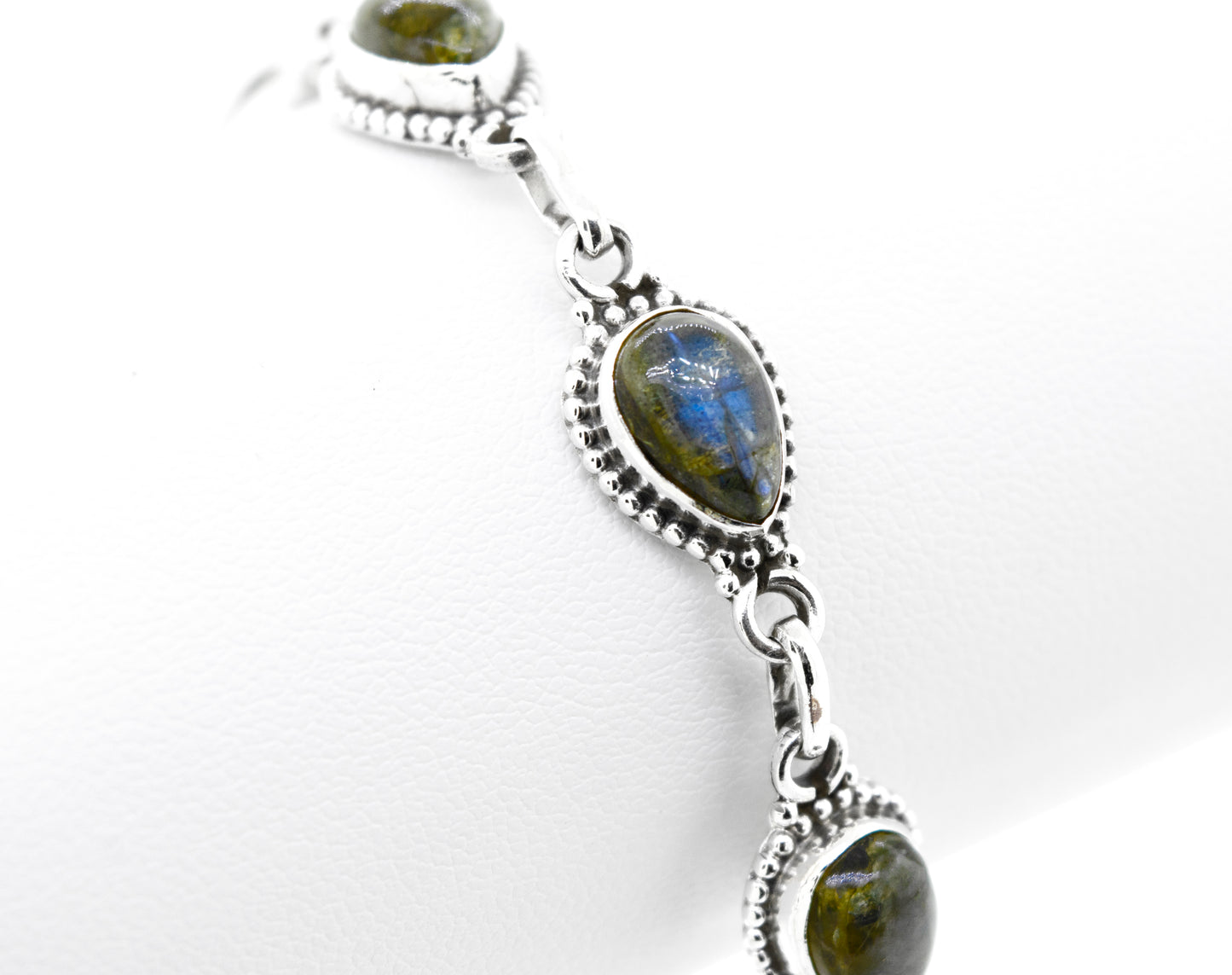 A vibrant silver Super Silver bracelet adorned with teardrop-shaped blue labradorite stones.