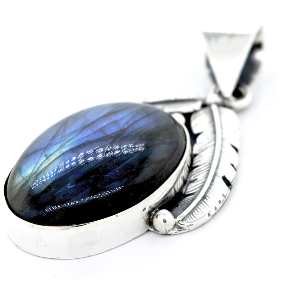 
                  
                    Beautiful Southwest Stone Pendant featuring an oval-shaped labradorite gemstone and an intricate feather design.
                  
                