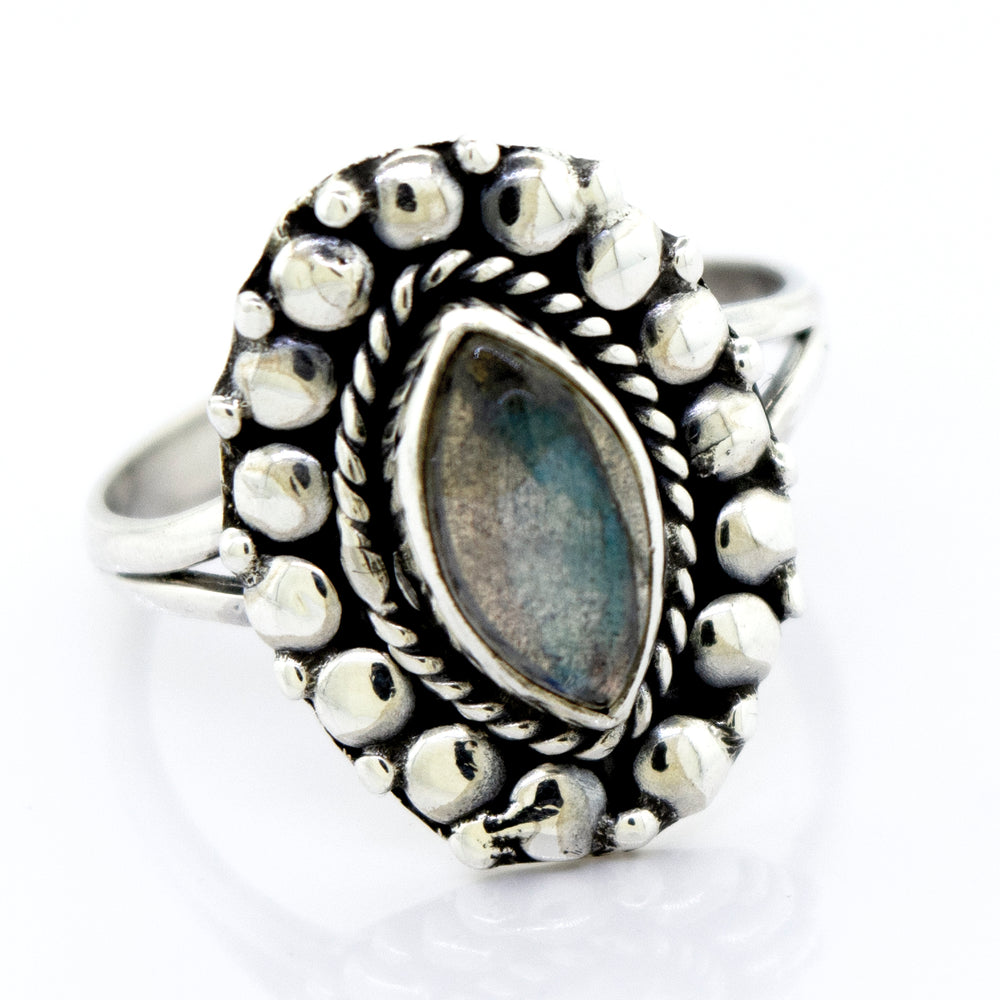 
                  
                    A Super Silver Marquise Shaped Vibrant Labradorite Stone Ring in a beaded design.
                  
                