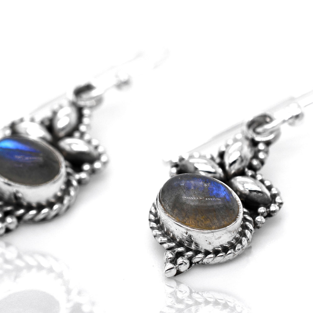 
                  
                    A pair of Super Silver's Captivating Petite Stone Earrings with labradorite stones - perfect for those who appreciate dainty jewelry and stunning gemstones.
                  
                