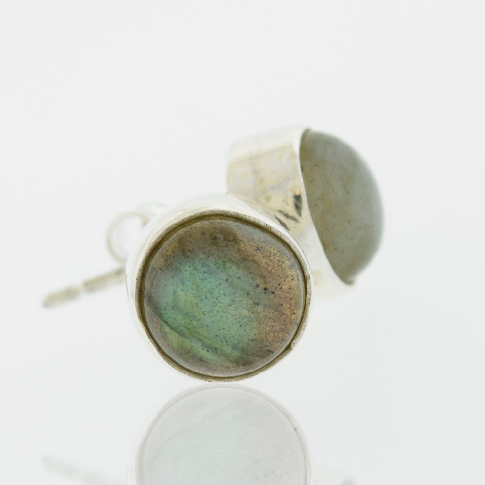 A pair of Simple Circle Labradorite Studs from Super Silver, perfect for everyday wear, crafted from .925 Sterling Silver and placed delicately on a white surface.