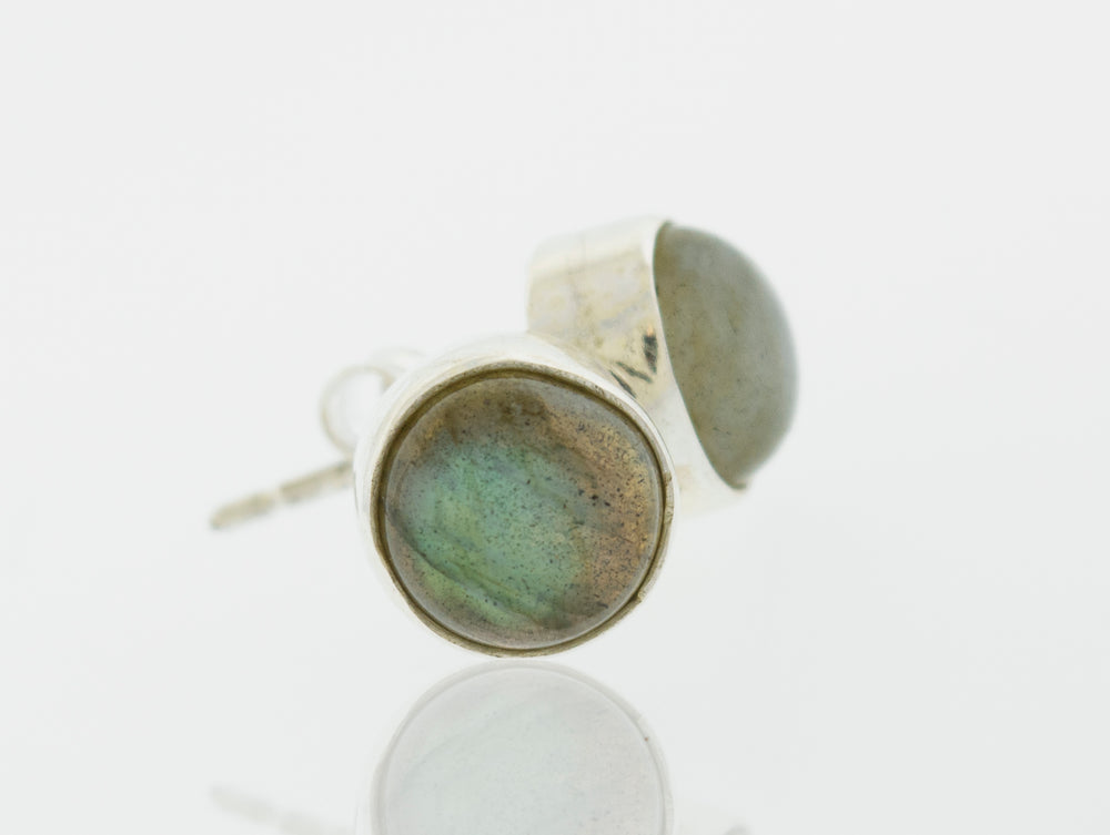 A pair of Simple Circle Labradorite Studs from Super Silver, perfect for everyday wear, crafted from .925 Sterling Silver and placed delicately on a white surface.