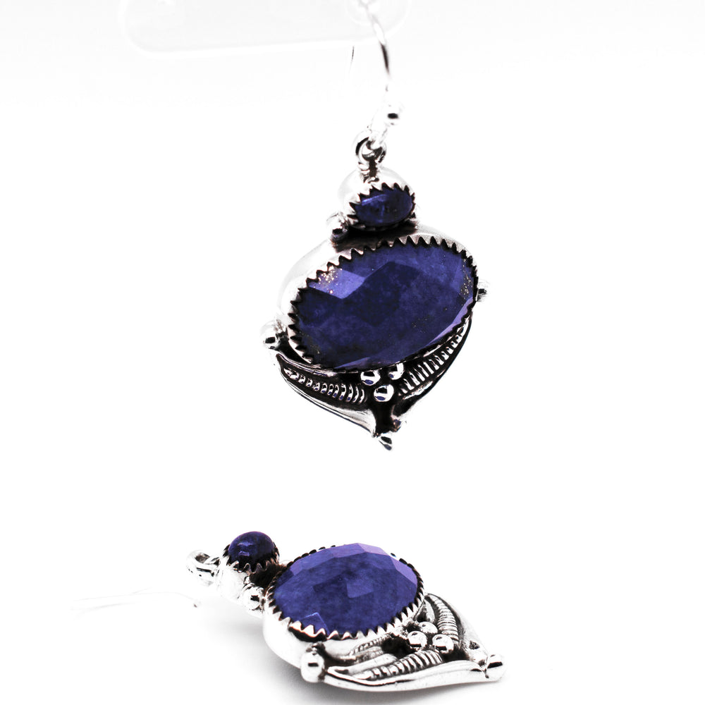 
                  
                    A pair of Super Silver Spectacular Faceted Gemstone Earrings with blue stones.
                  
                