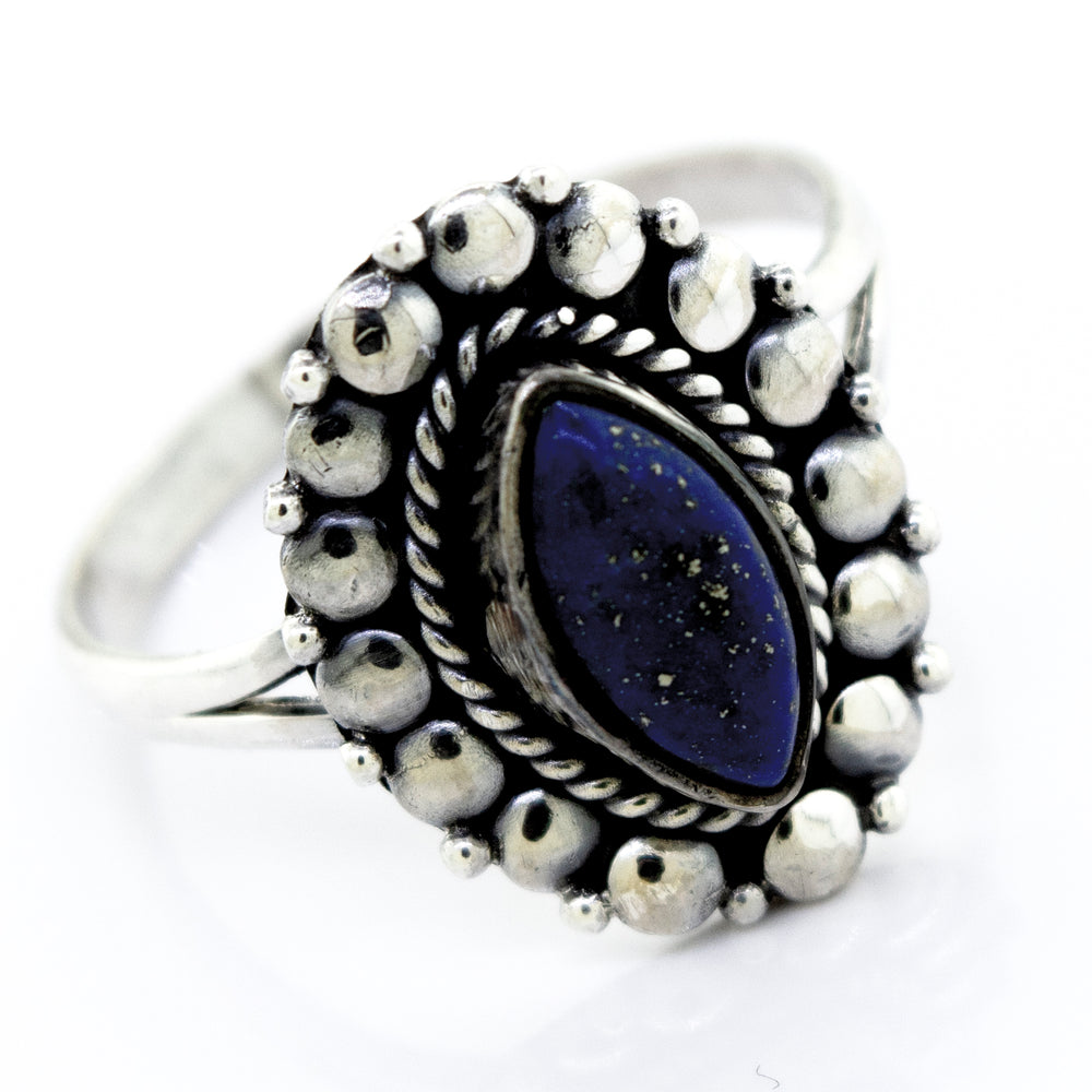 A stunning Super Silver Marquise Shaped Vibrant Lapis Ring with a lapis stone in the center, showcasing a beaded design on the setting.