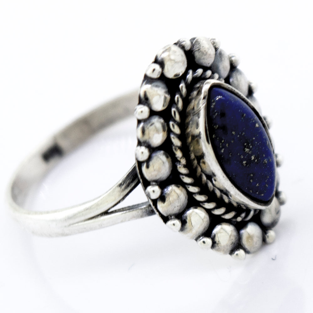 
                  
                    A Marquise Shaped Vibrant Lapis Ring by Super Silver in a beaded design setting.
                  
                