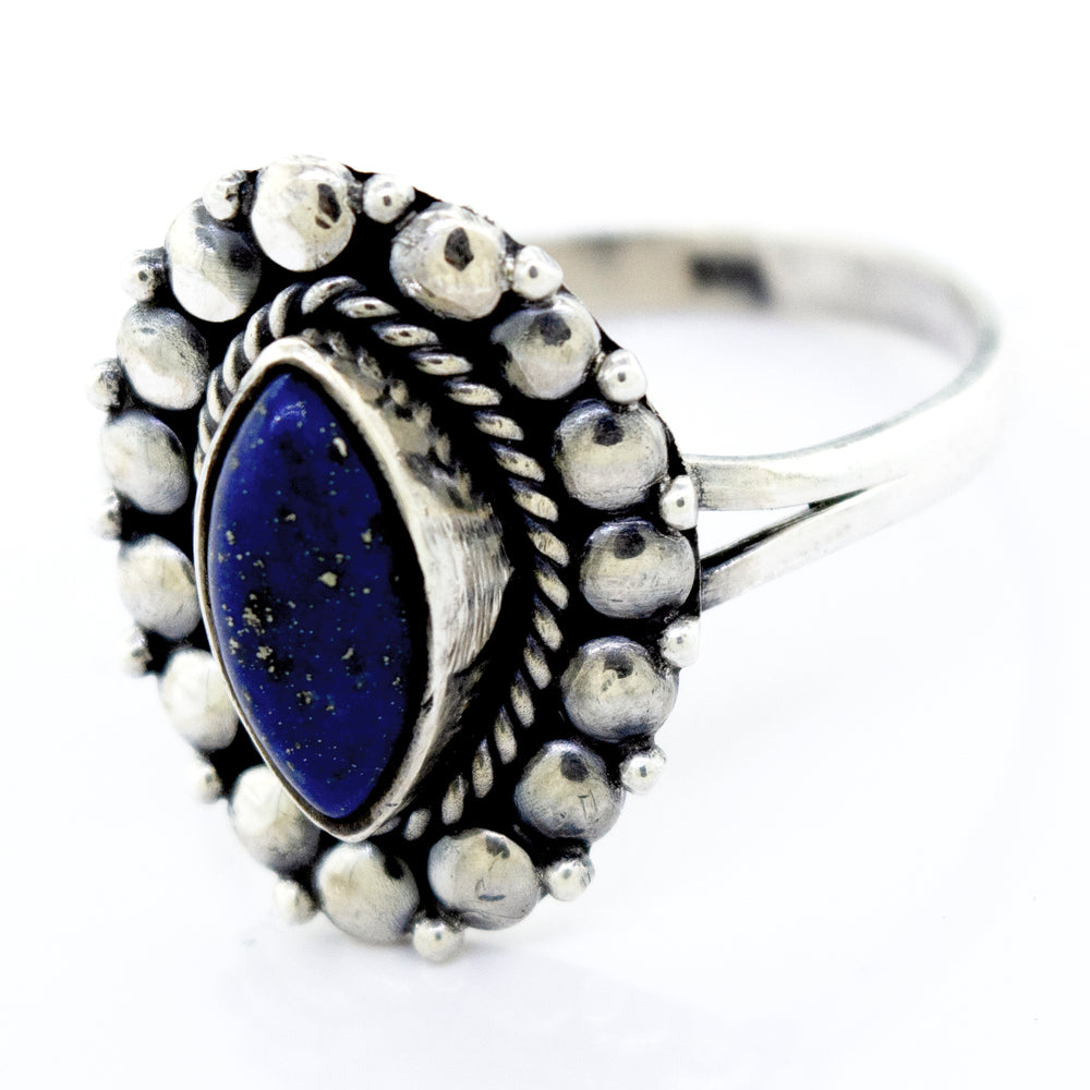 A Marquise Shaped Vibrant Lapis Ring by Super Silver, with the lapis stone in the center, featuring a beaded design in the silver setting.