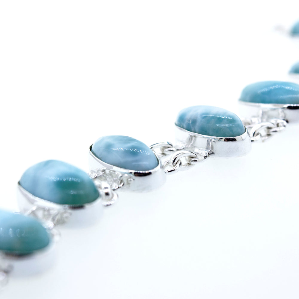 A Beautiful Oval Larimar Bracelet with blue and white stones, perfect for a beach outfit from Super Silver.