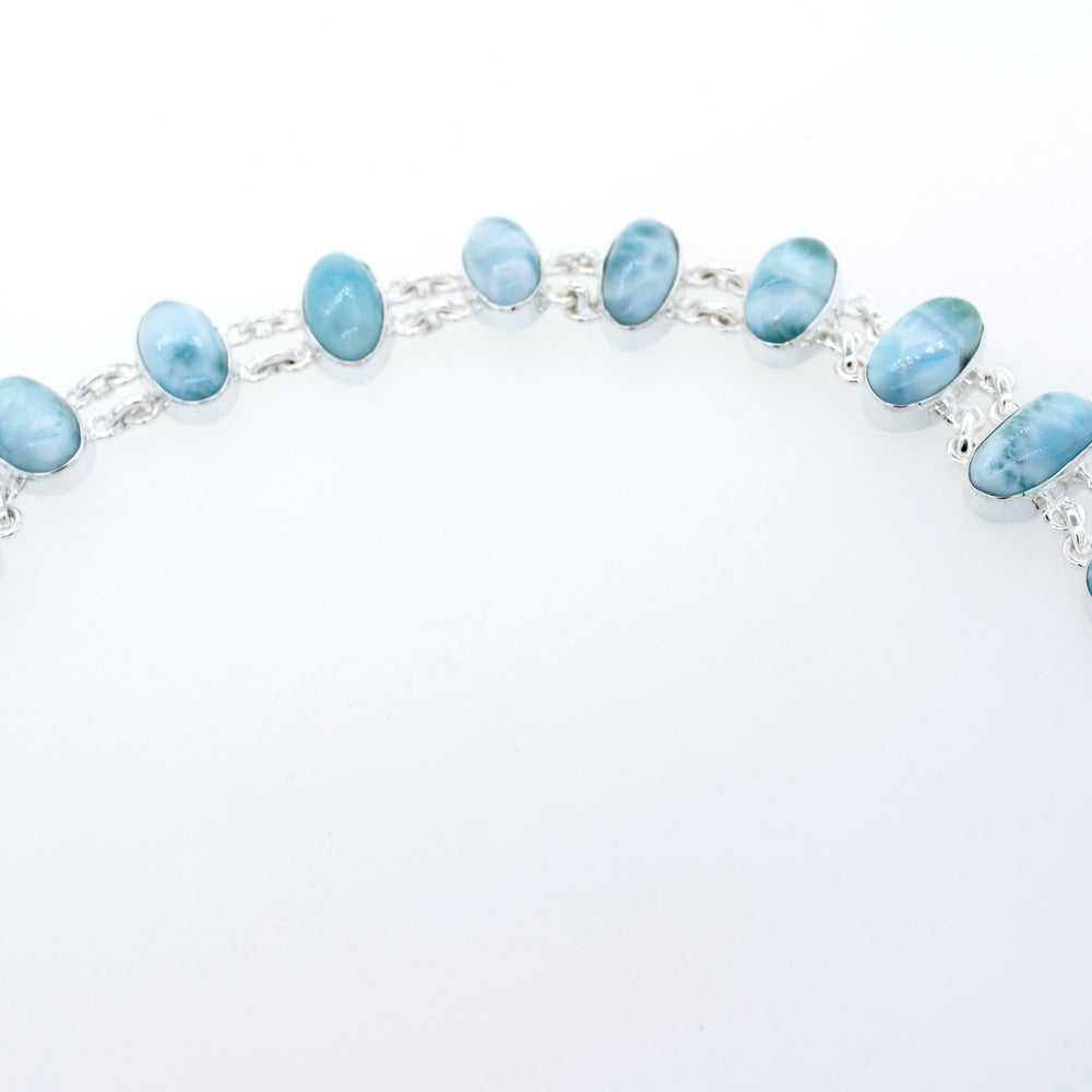 
                  
                    A stunning Beautiful Oval Larimar Bracelet adorned with larimar stones from Super Silver, perfect for complementing your beach outfit.
                  
                