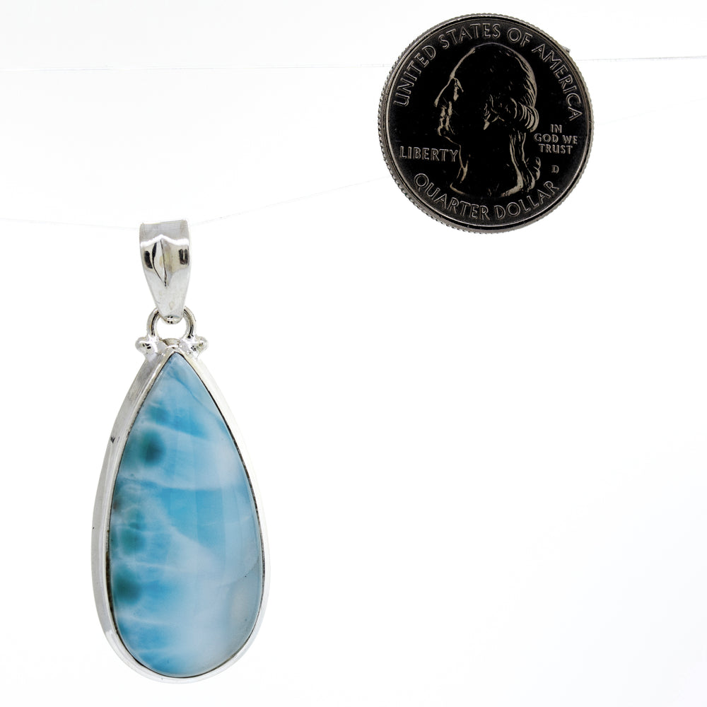 
                  
                    This eye-catching Super Silver pendant features a stunning Medium Teardrop Larimar stone, perfect for adding a touch of elegance to any occasion.
                  
                