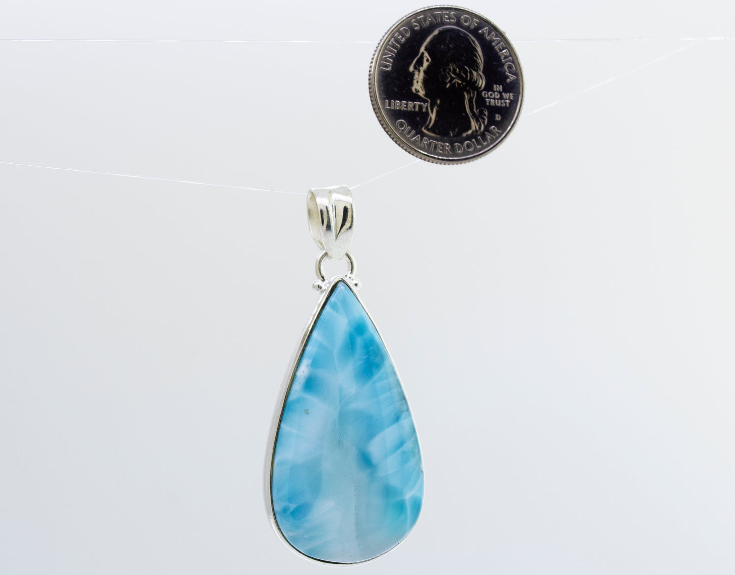 
                  
                    A dazzling Larger Teardrop Larimar Pendant adorned with a mesmerizing blue larimar stone, made by Super Silver.
                  
                