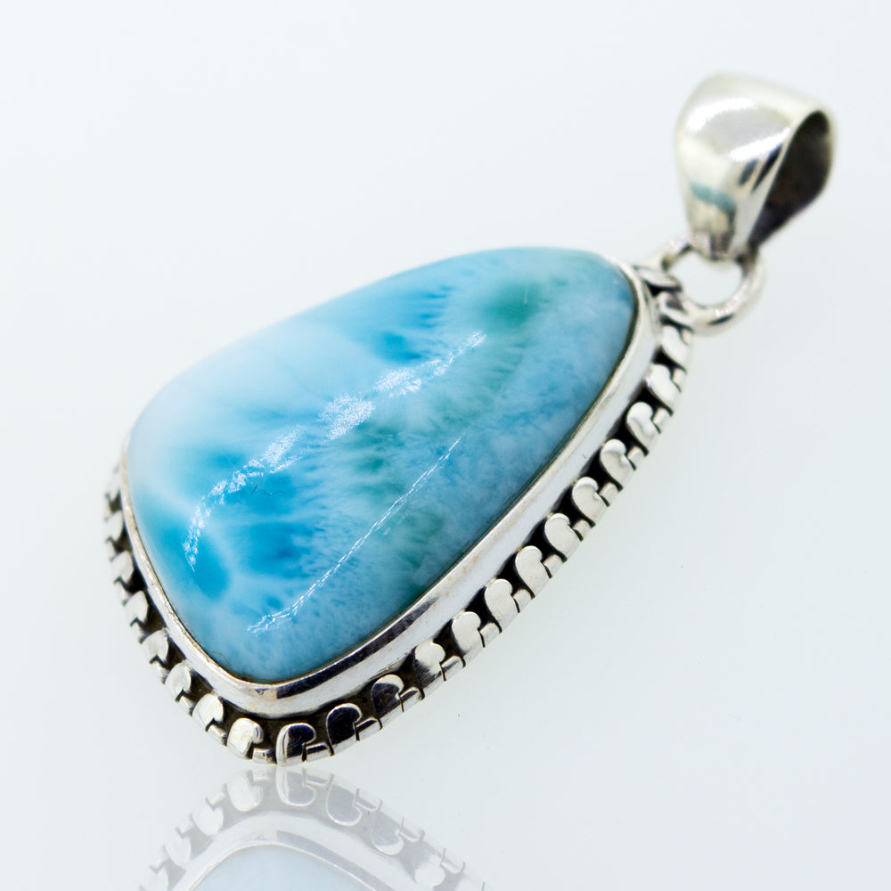 A stunning Medium Larimar Pendant with Ball Border by Super Silver, measuring 1.5 inches in length, showcasing a blue larimar stone set in .925 Sterling Silver.