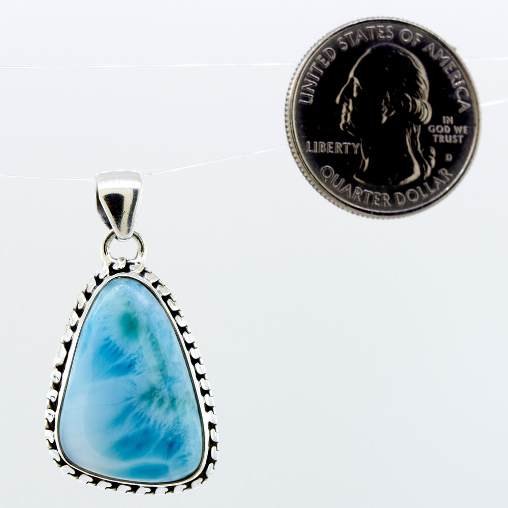 
                  
                    A stunning piece of jewelry, this Super Silver Medium Larimar Pendant with Ball Border features a beautiful blue agate stone. Measuring 1.5 inches in length, it adds a touch of elegance to any outfit.
                  
                