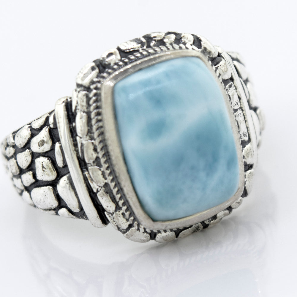 A Larimar signet ring with a large blue stone.