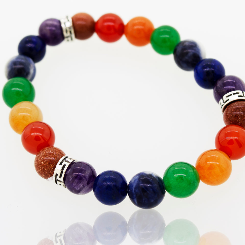 A stylish Chakra Stone Beads Bracelet adorned with a vibrant rainbow colored bead, imbued with energizing properties by Super Silver.
