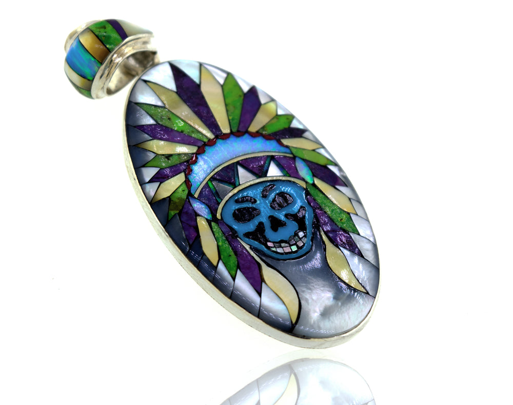 A unique Super Silver handcrafted pendant featuring the Handcrafted Chief Skull Pendant and feathers.