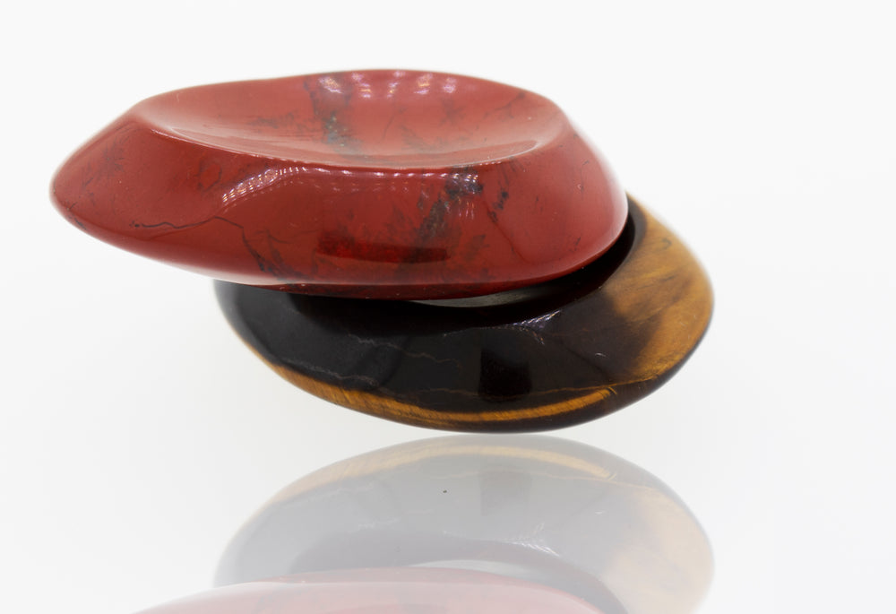 A red, black and yellow worry stone ring with a crystal stone.