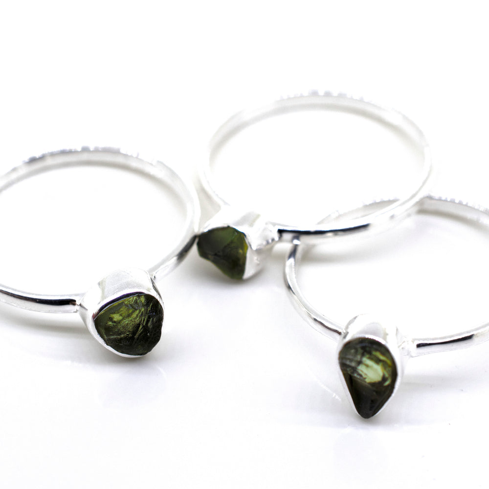 
                  
                    Three Super Silver rings with green tourmaline stones on a white surface, featuring a sterling silver setting.
                  
                