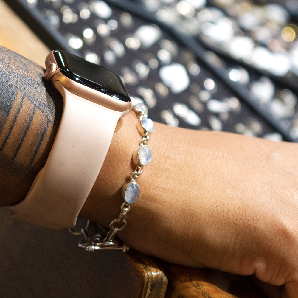 
                  
                    A woman wearing a Super Silver Vibrant Oval Moonstone Bracelet on her wrist.
                  
                