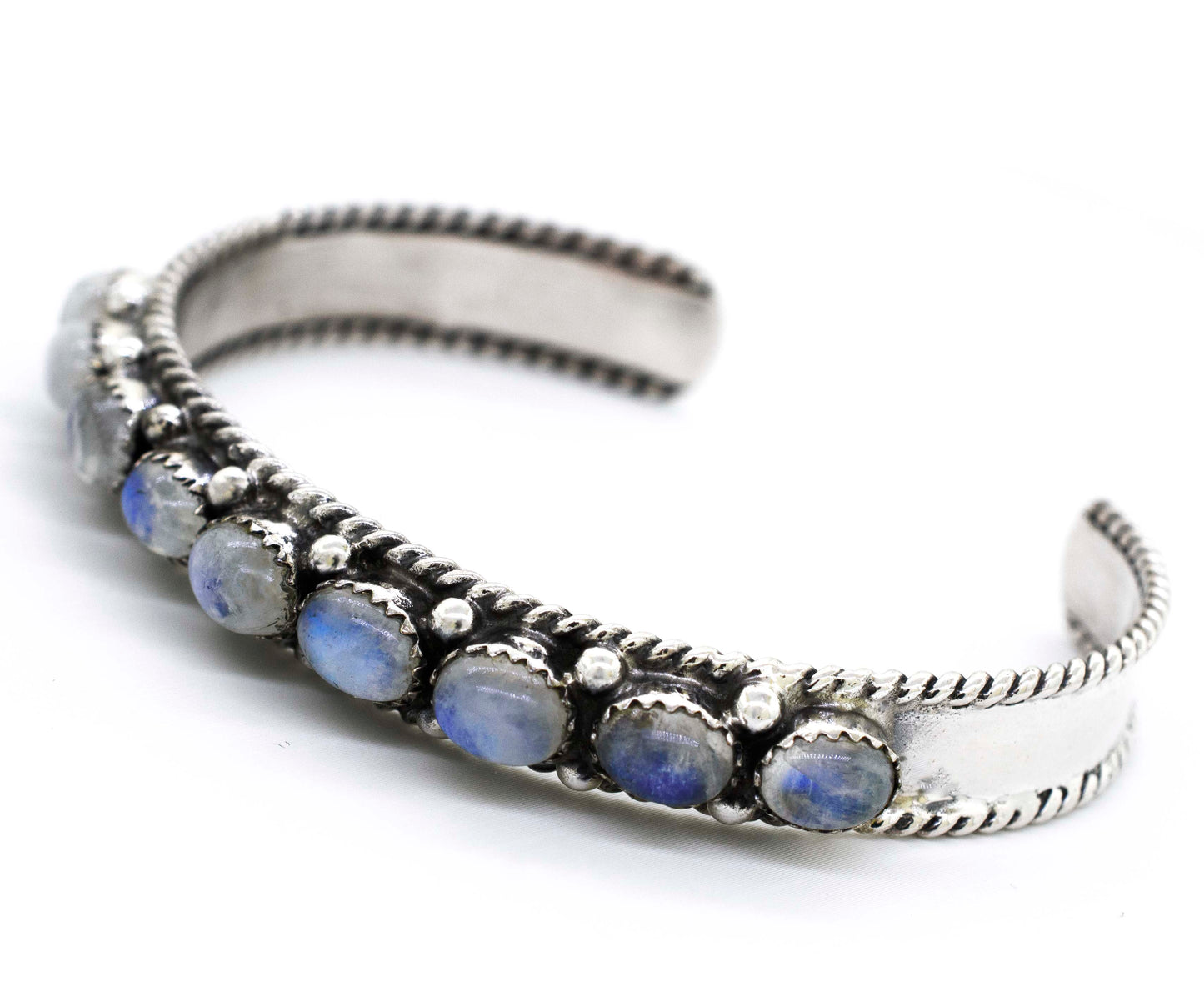 
                  
                    A Super Silver Oval Moonstone Cuff Bracelet adorned with blue stones will take you on a celestial journey.
                  
                