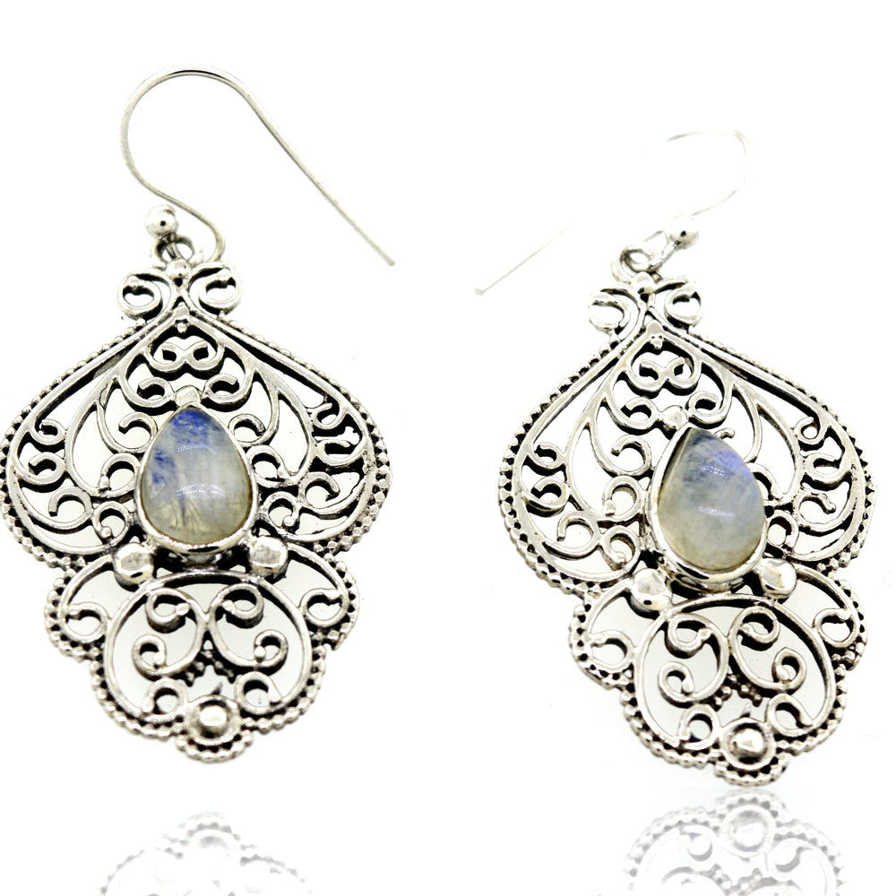 
                  
                    A pair of Teardrop Moonstone Earrings With Freestyle Silver Design by Super Silver featuring a vibrant blue moonstone.
                  
                