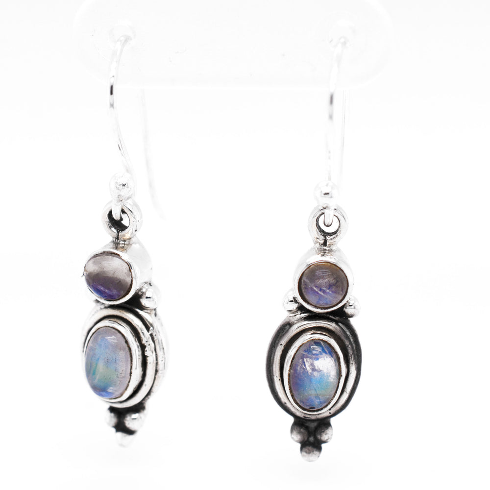 
                  
                    A pair of Goddess Shape Gemstone Earrings by Super Silver with blue opal stones.
                  
                