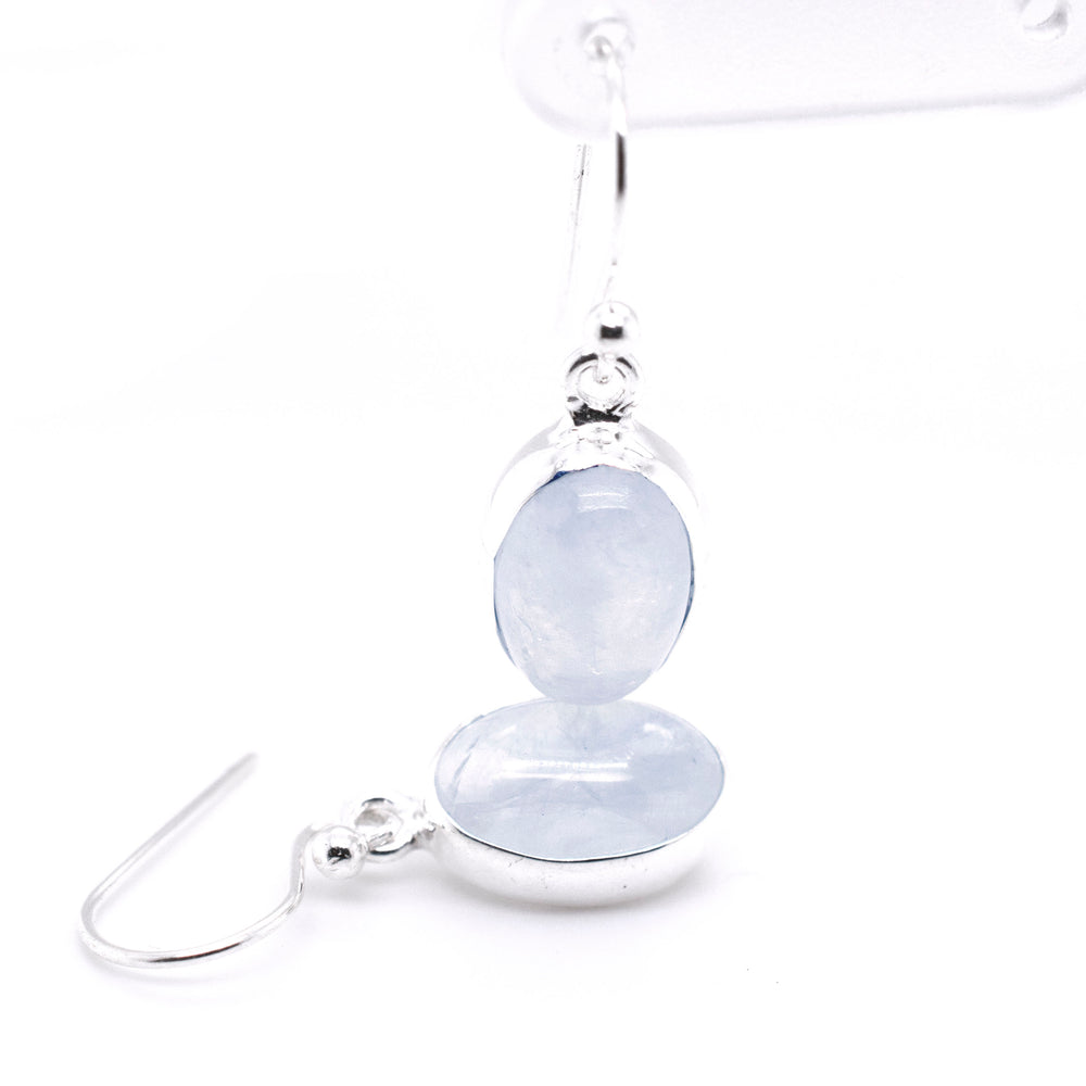 
                  
                    A pair of Simple Oval Moonstone Earrings by Super Silver with a blue quartz stone.
                  
                