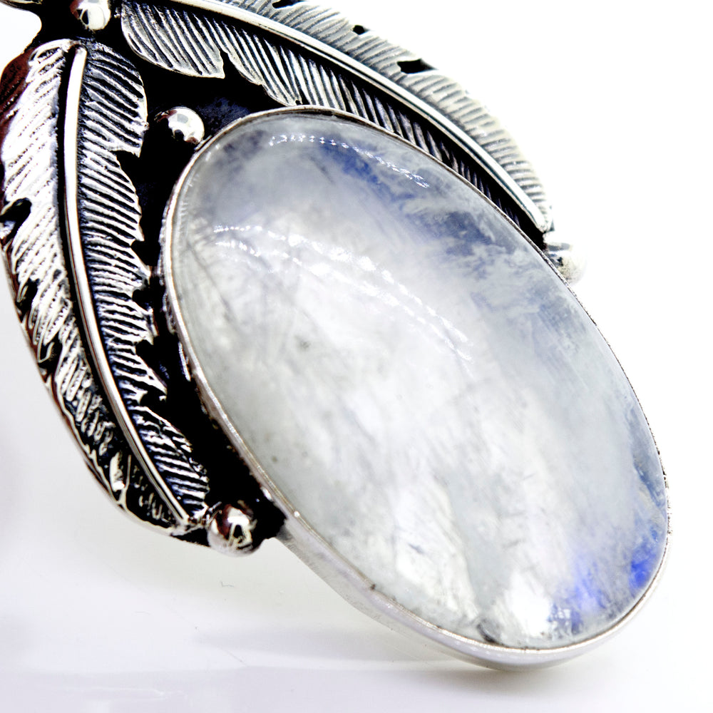 A Super Silver moonstone pendant with feathers.