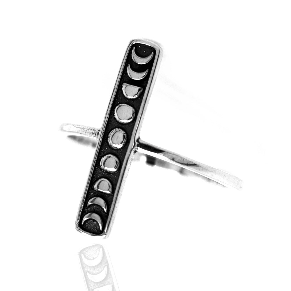 A minimalist Elongated Moon Phases Ring by Super Silver, showcasing the phases of the moon.