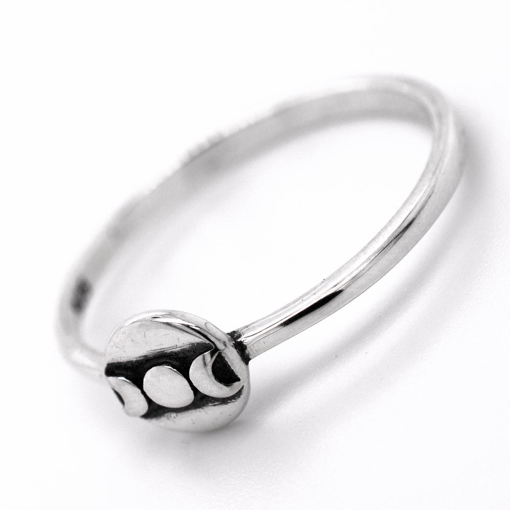 
                  
                    An interstellar Dainty Moon Phases Ring with a circle on it by Super Silver.
                  
                
