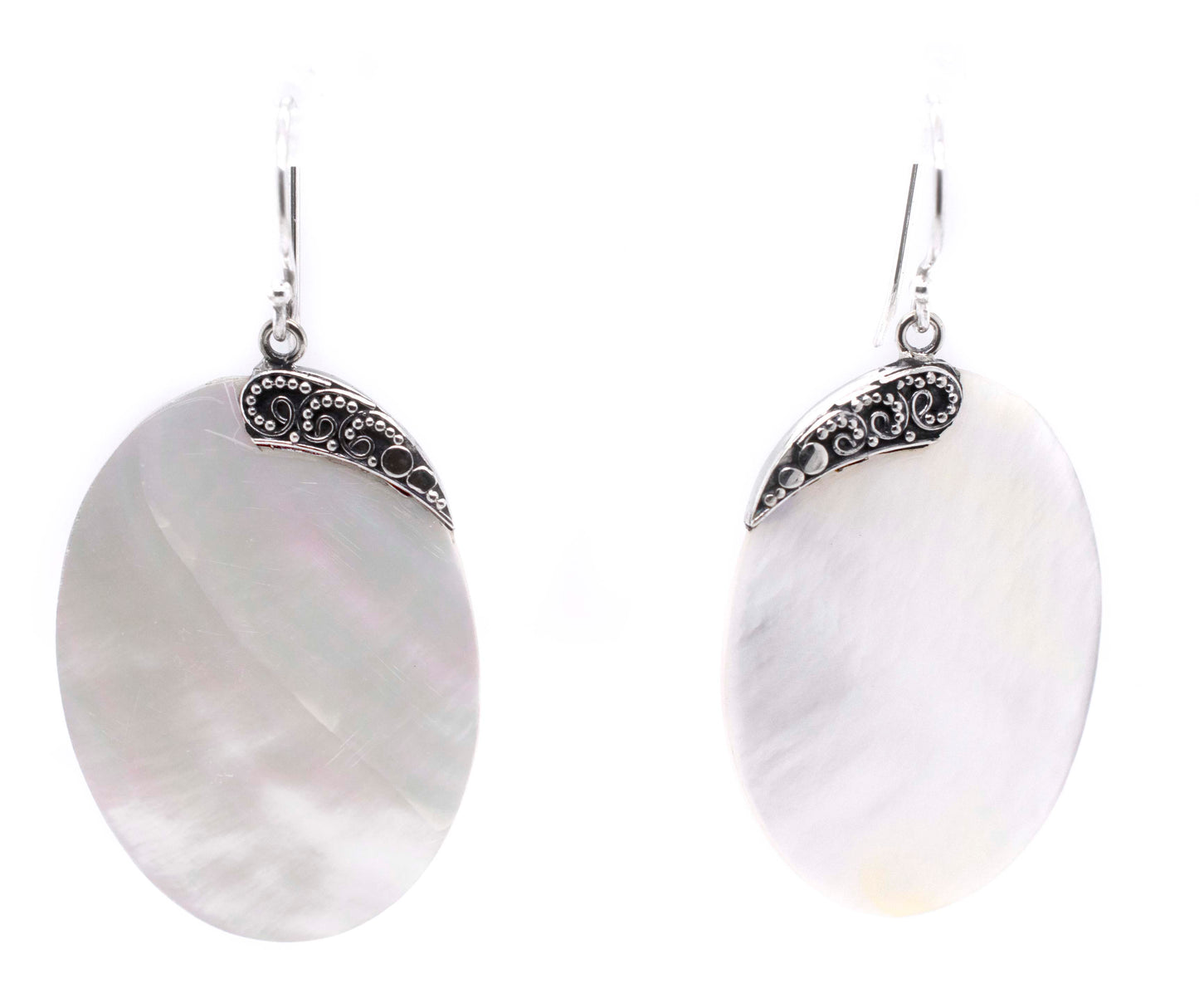 
                  
                    A pair of Simple Mother Of Pearl Statement Earrings adorned with intricate silverwork by Super Silver.
                  
                