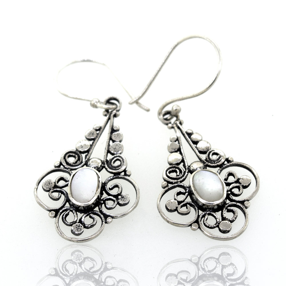 
                  
                    A pair of Oval Mother Of Pearl Dangle Earrings with a flower design from Super Silver.
                  
                