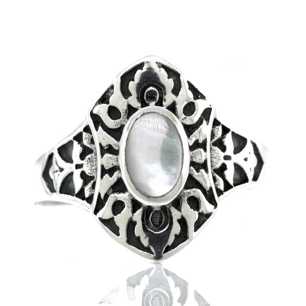 An ornate Super Silver Marquise Shield Ring With Inlaid Stones with an inlaid mother of pearl.