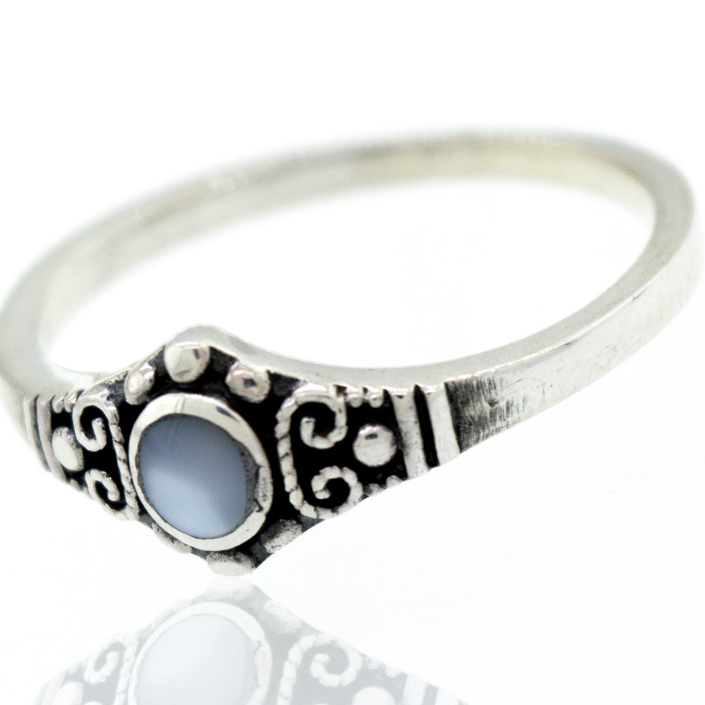 
                  
                    A Super Silver Dainty Inlaid Stone Ring With Silver Beads and Swirls with a blue stone and antiqued finish.
                  
                