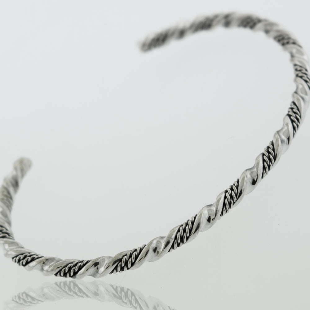 
                  
                    A Native American Handmade Silver Rope Twist Cuff bracelet with an intricate design, made by Super Silver.
                  
                
