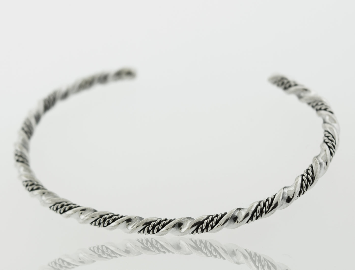A Native American Handmade Silver Rope Twist cuff bracelet with an intricate braided design by Super Silver.