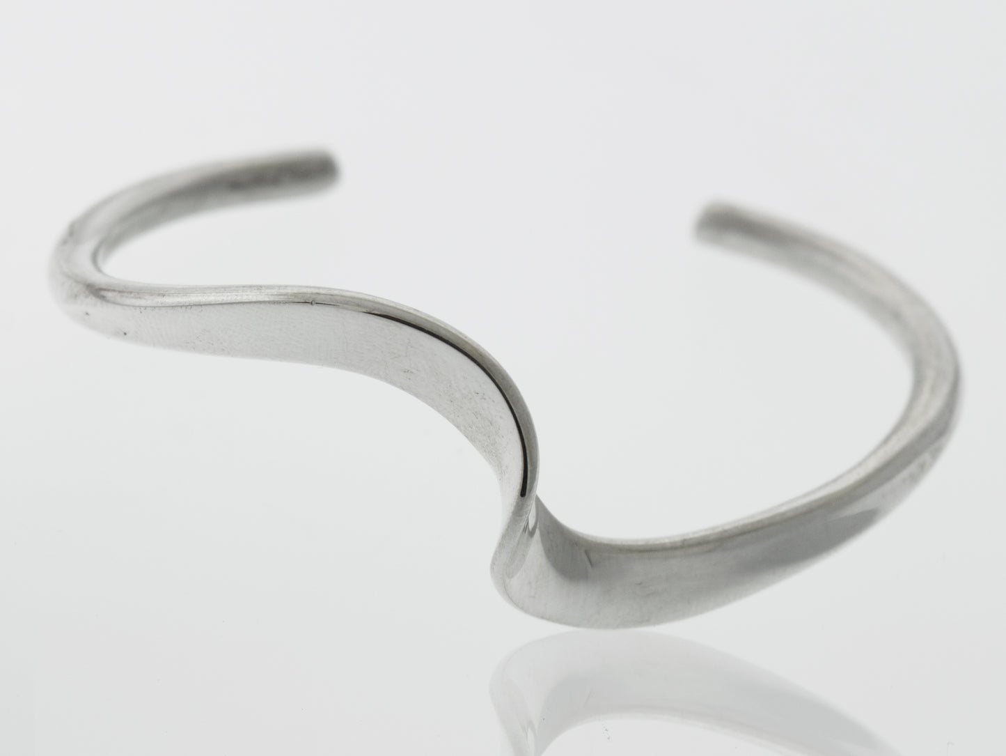 A simple Native American Handmade Thick Silver Wave Cuff bracelet with a curved shape, perfect as a gift from Super Silver.