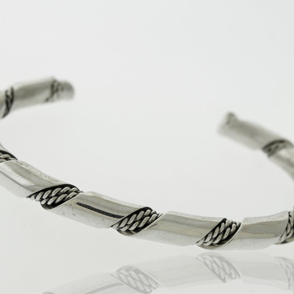 An elegant statement piece, the Native American Handmade Thick Silver Twist Cuff bracelet by Super Silver with a braided design is perfect for any outing. Made with .925 Sterling Silver.