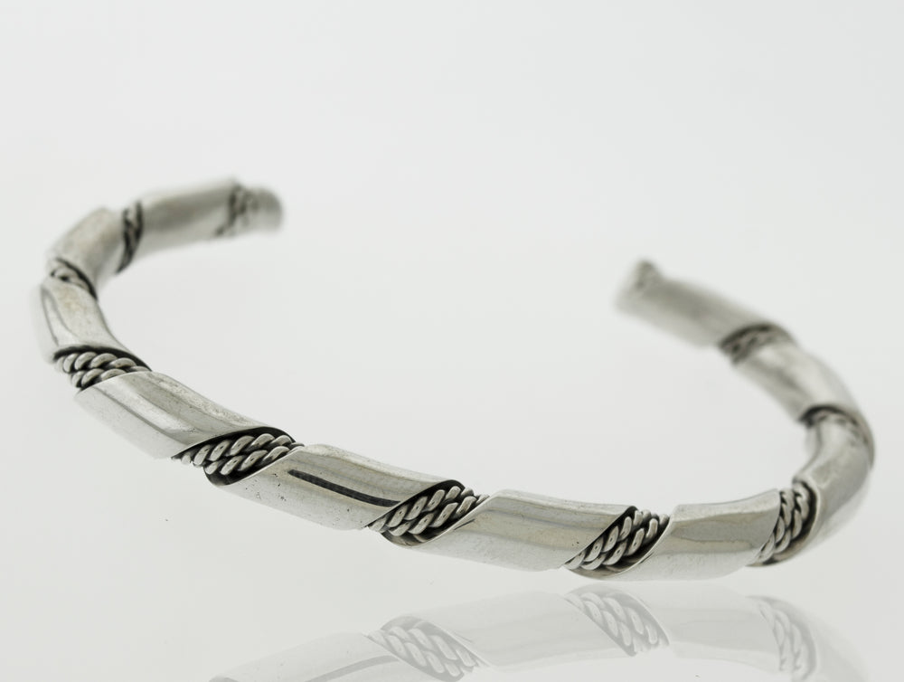 
                  
                    An elegant statement piece, the Native American Handmade Thick Silver Twist Cuff bracelet by Super Silver with a braided design is perfect for any outing. Made with .925 Sterling Silver.
                  
                