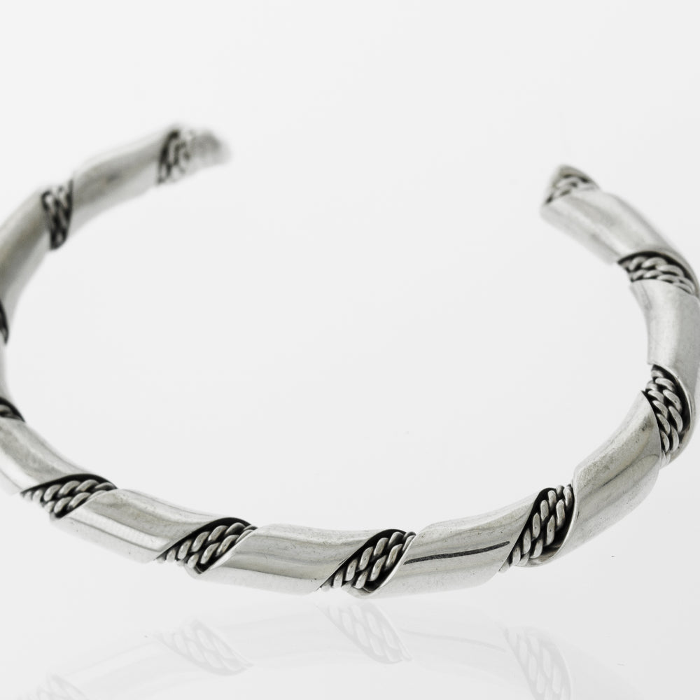 
                  
                    An elegant statement piece, the Super Silver Native American Handmade Thick Silver Twist Cuff bracelet showcases a beautiful braided design, making it perfect for any outing.
                  
                