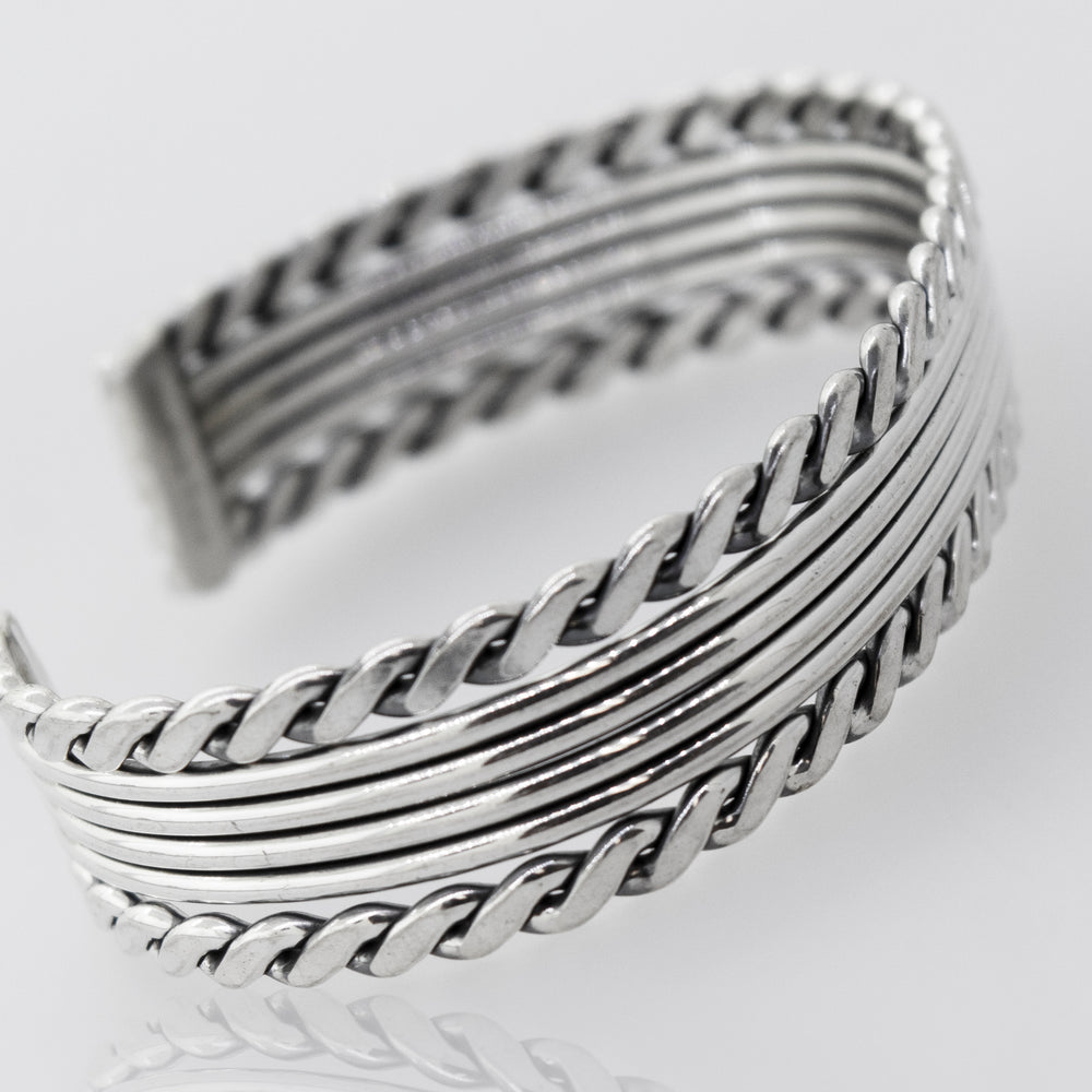 A "Native American Handmade Thick Silver Cuff with a Rope Border" bracelet made of .925 Sterling Silver measuring 6 inches by Super Silver.