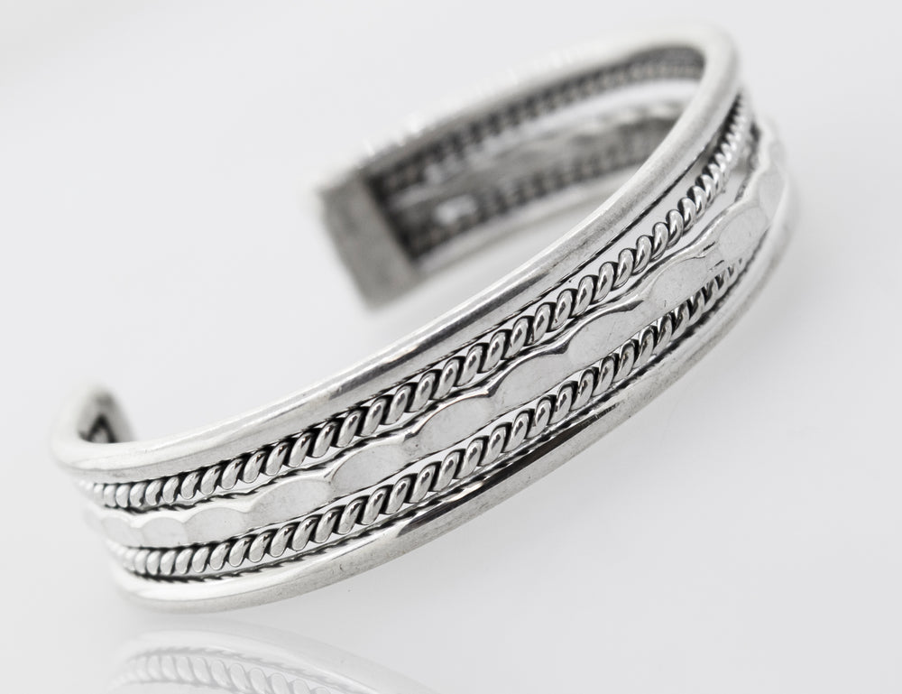 A detailed Native American Handmade Intricate Silver Cuff bracelet from the Super Silver collection, made of .925 Sterling Silver with a braided design.