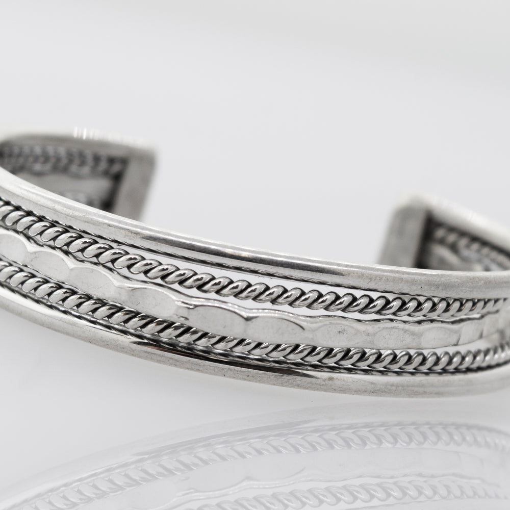 
                  
                    A Native American Handmade Intricate Silver Cuff bracelet from Super Silver, with a detailed braided design, perfect for your collection.
                  
                