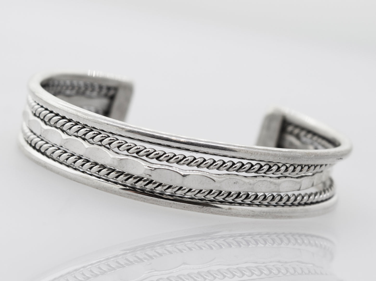 
                  
                    A Native American Handmade Intricate Silver Cuff bracelet from Super Silver, with a detailed braided design, perfect for your collection.
                  
                