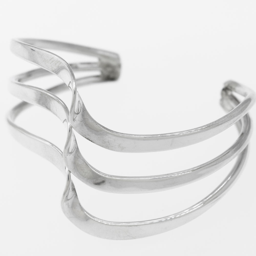 A Native American Handmade Silver Triple Wave Cuff by Super Silver, carefully crafted to shine.